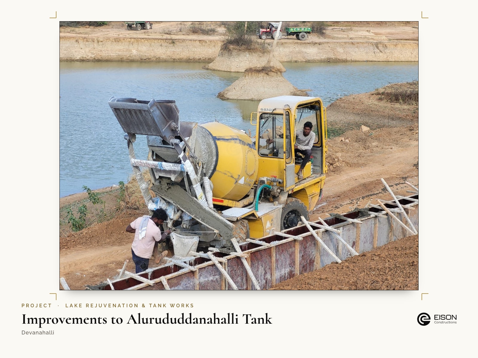 Improvements to Alurududdanahalli Tank, Devanahalli: concrete being placed for the bund wall beside the water