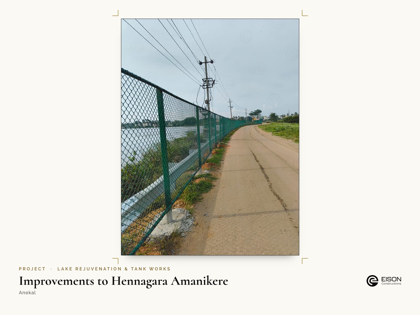 Improvements to Hennagara Amanikere, Anekal: green chain-link fencing along the lake road